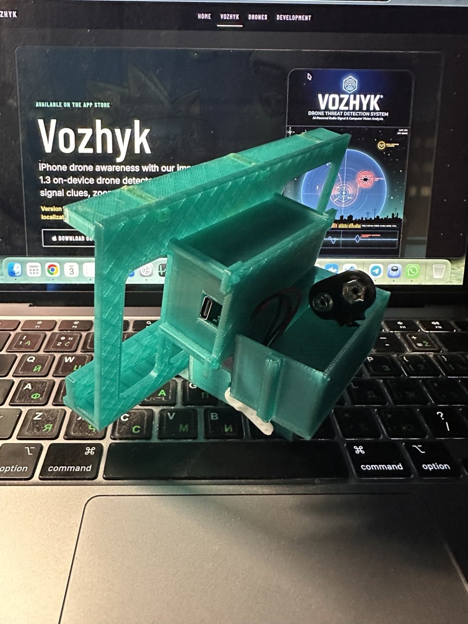 Rear angled view of the green 3D-printed Vozhyk Picatinny attachment prototype